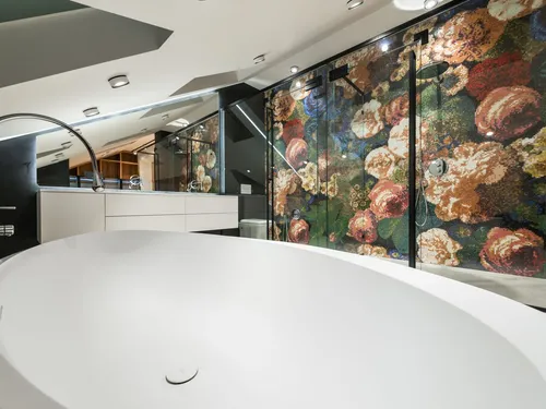 Contemporary bathroom with a freestanding bath and a floral mosaic shower wall