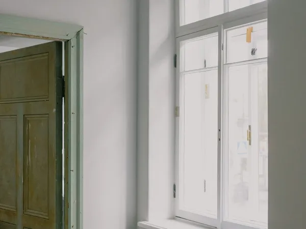 Column radiator beneath a window in a room being renovated